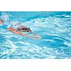 Pretty female swimmer in a pool, getting her daily dose of exercise without stressing her joints