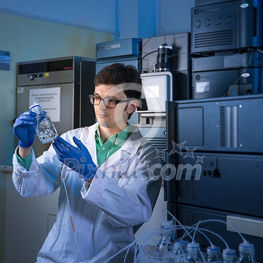 Senior male researcher carrying out scientific research in a lab (shallow DOF; color toned image)