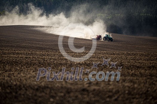 Tractor plowing a dry farm field