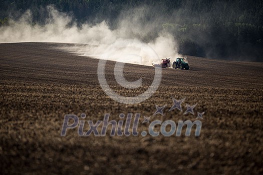 Tractor plowing a dry farm field Tractor plowing a dry farm field