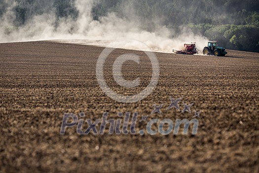 Tractor plowing a dry farm field Tractor plowing a dry farm field