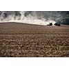 Tractor plowing a dry farm field