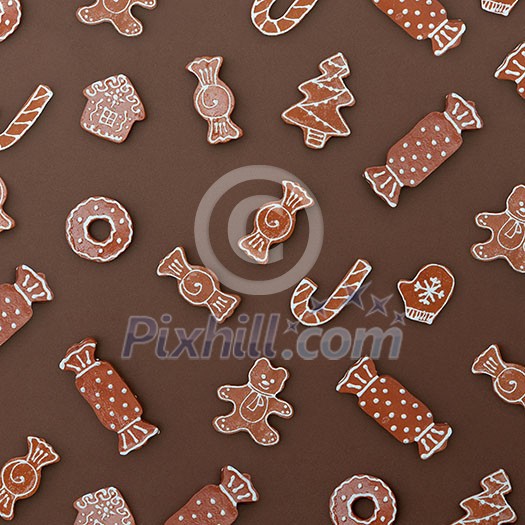 Homemade Gingerbread cookies with different shapes isolated on a brown background. Christmas background
