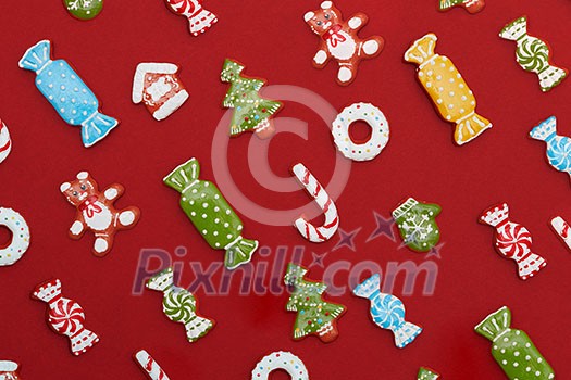 Christmas background. Homemade delicious Christmas gingerbread cookies on a red background.