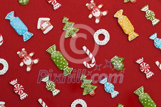 Christmas background. Homemade delicious Christmas gingerbread cookies on a red background. Christmas background. Homemade delicious Christmas gingerbread cookies on a red background.