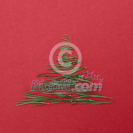 Christmas tree pine needles on a red background. Christmas concept. Christmas tree pine needles on a red background. Christmas concept.