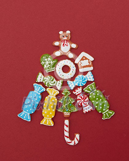 Beautiful Christmas tree made of gingerbread cookies with icing on a red background Beautiful Christmas tree made of gingerbread cookies with icing on a red background