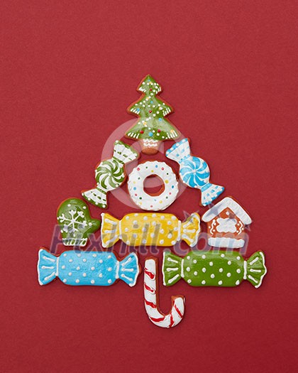 Beautiful Christmas tree made of gingerbread cookies with icing on a red background Beautiful Christmas tree made of gingerbread cookies with icing on a red background