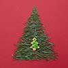 Two Christmas tree on red background. Christmas tree made of pine needles with the decoration of Christmas cookies