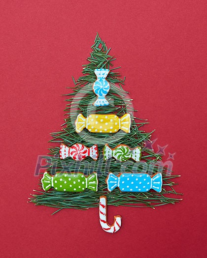 Christmas card with fir-tree needles and sweets of Christmas cookies. Postcard Happy New Year.