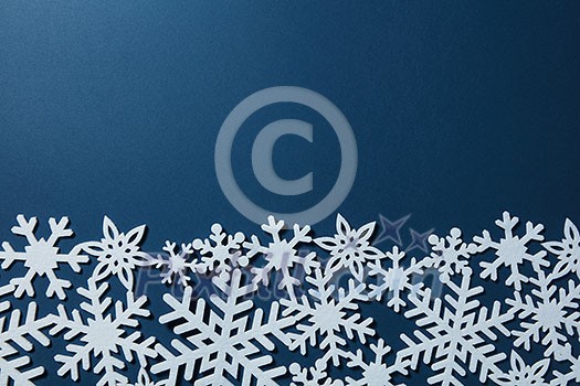 border of white snowflakes on a blue background. Christmas card