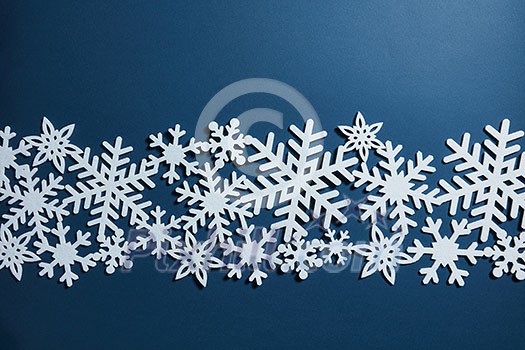 Christmas blue background with white snowflakes. Christmas postcard