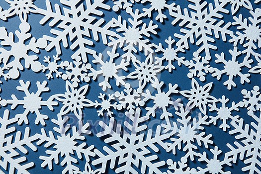 Christmas background with different snowflakes on a blue background