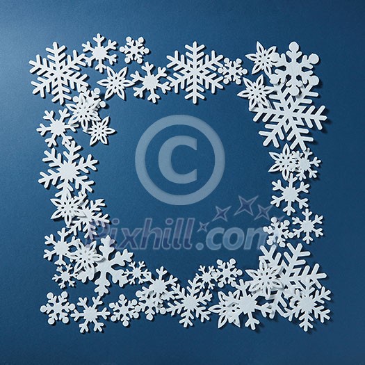 Frame of Christmas snowflakes on blue background