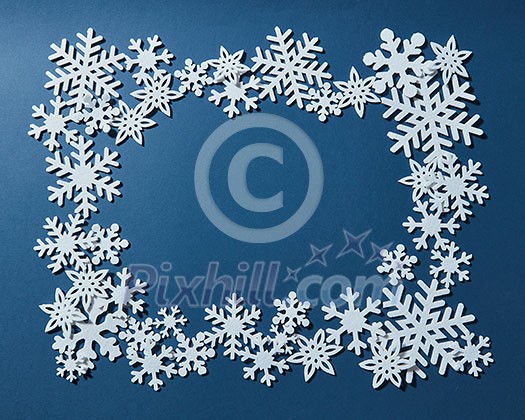 Christmas decorative frame of snowflakes. On a blue background.
