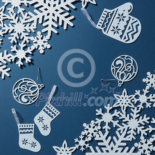 Background for Christmas card with snowflakes and decorations on blue background