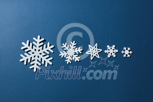 snowflakes of different sizes on a blue background
