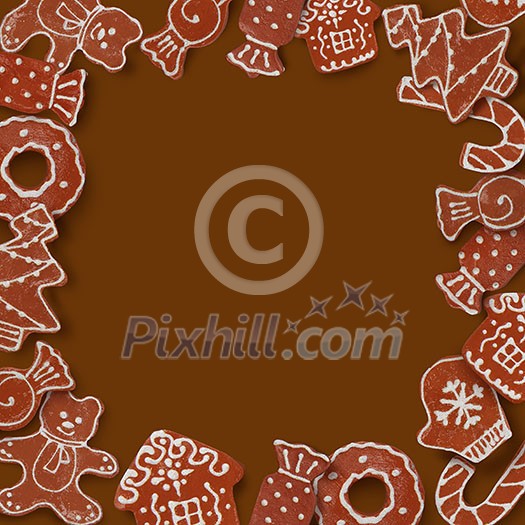 Christmas card with frame made of ginger cookies on a brown background
