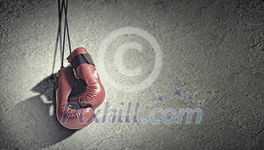 Pair of red boxing gloves hanging on wall