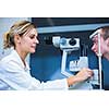 Optometry concept - handsome young man having his eyes examined by an eye doctor (color toned image; shallow DOF)