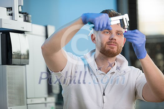 Senior male researcher carrying out scientific research in a lab (shallow DOF; color toned image)