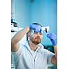 Senior male researcher carrying out scientific research in a lab (shallow DOF; color toned image)