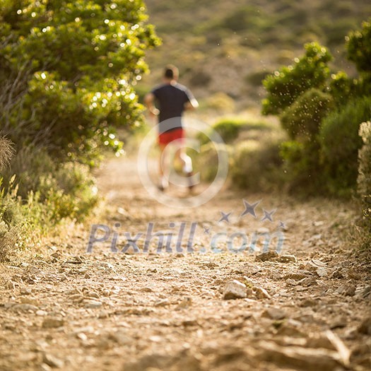 Young man running outdoors on a lovely sunny day Young man running outdoors on a lovely sunny day