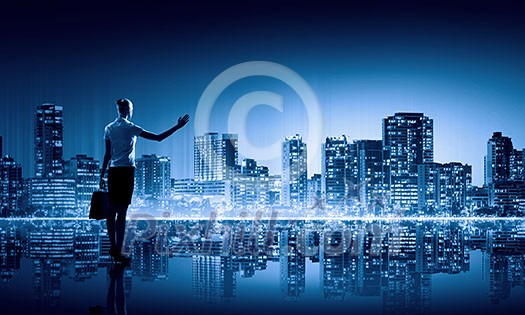 Businesswoman standing with back against night city panoramic view Businesswoman standing with back against night city panoramic view
