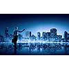Businesswoman standing with back against night city panoramic view