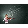 Adorable boy wearing red bowtie and playing violin