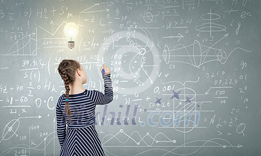 Cute girl of school age and blackboard on background