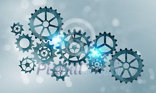 Mechanism of metal gears and cogwheels on blue background