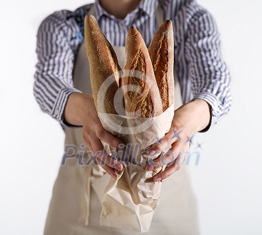 Baker's hands hold fresh bread isolated on white background.