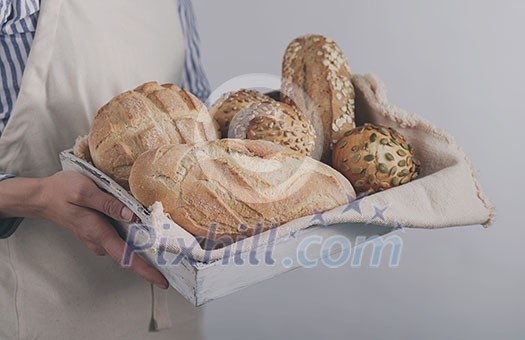 Baker's hands hold fresh bread. Baker's hands hold fresh bread.