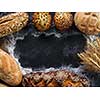 Assortment of fresh bread on the dark table. Copyspace for text.