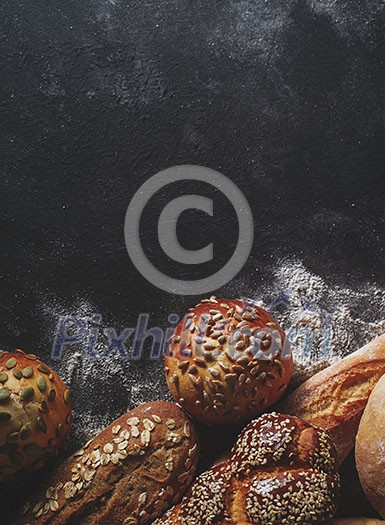 Assortment of fresh bread on the table. Copyspace for text.