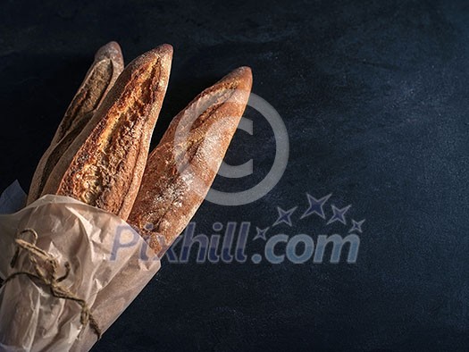 Three freshly baked baguettes on the table