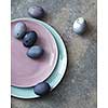 pink and blue plate with Easter eggs hand-made robotic concrete background flat lay