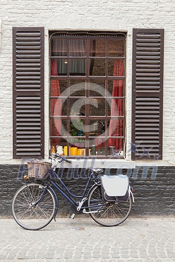 Retro bicycle standing near the old window, Belgium