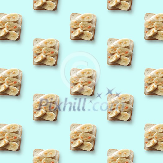 sandwiches with banana on blue background, pattern flat lay