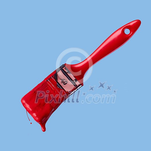 red brush and drop of paint on a blue background red brush and drop of paint on a blue background