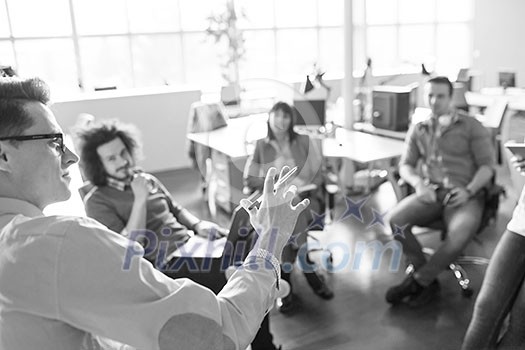 Group of a young business people discussing business plan  in the office