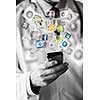 Hand holding smart phone and social network icons flying