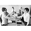 businesswomans handshake on team meeting  with group of people blured in background at modern startup business office interior