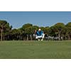 golf player aiming shot with club on course at beautiful sunny day