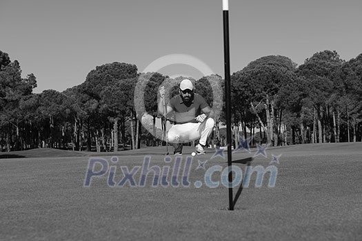golf player aiming shot with club on course at beautiful sunny day golf player aiming shot with club on course at beautiful sunny day