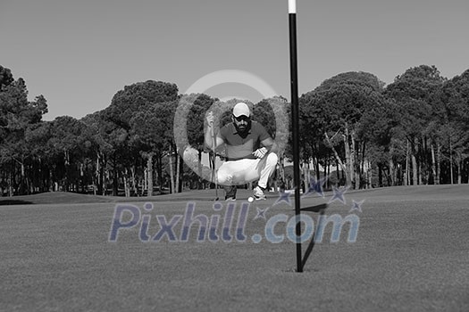 golf player aiming shot with club on course at beautiful sunny day