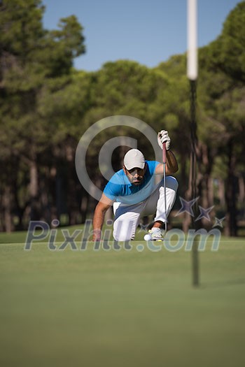 golf player aiming shot with club on course at beautiful sunny day