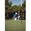 golf player aiming shot with club on course at beautiful sunny day