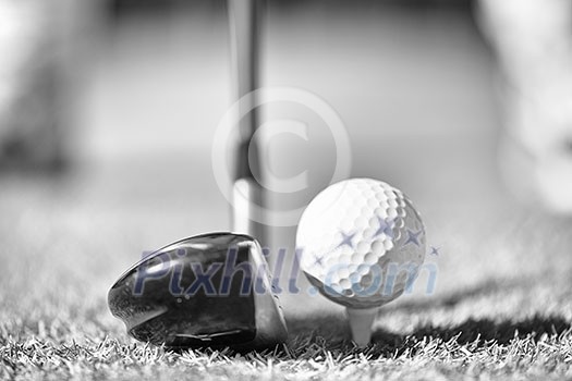 Golf club and ball in grass Golf club and ball in grass